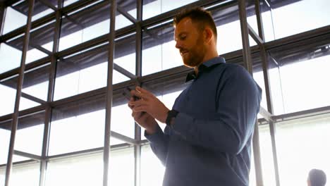 Man-using-mobile-phone-and-checking-time