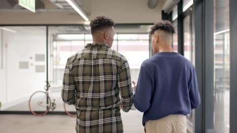 busy diverse businessmen talking and walking in office in slow motion