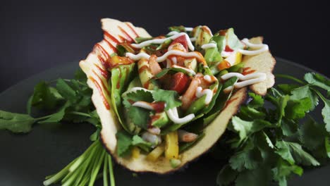 Frisch-Zubereiteter-Garnelen-Taco,-Rotierend-Auf-Schwarzem-Hintergrund-Mit-Rohem-Koriander,-4k