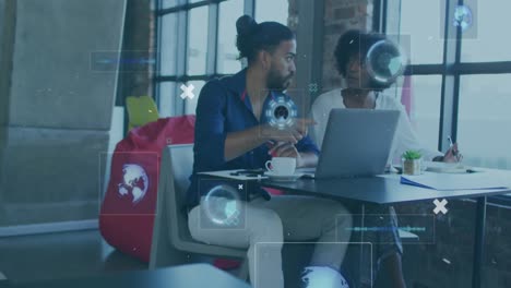 animation of digital interface with icons over biracial couple using technology