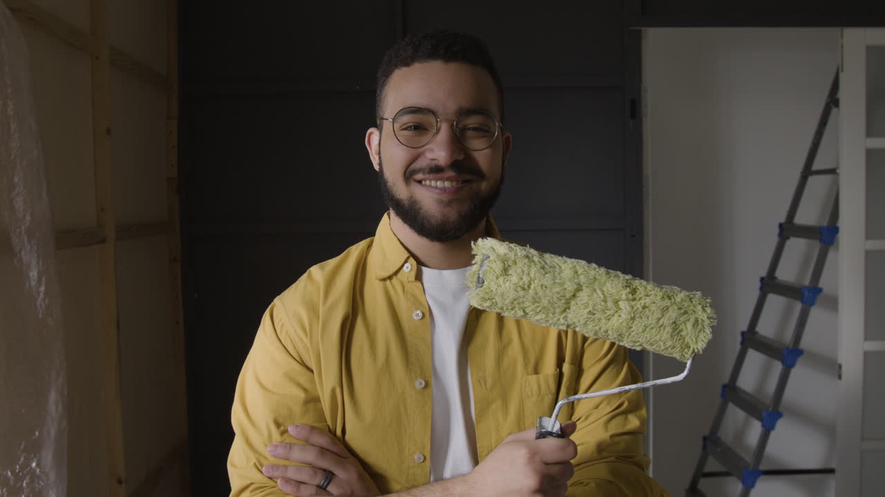 Man with paint roller ready for home improvement