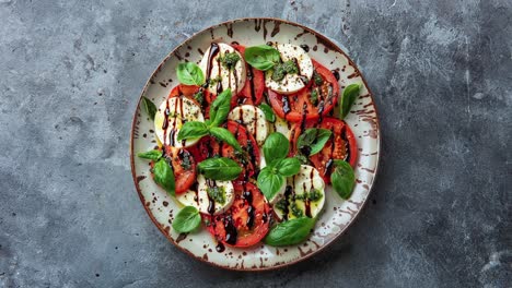 caprese salad with balsamic glaze and pesto