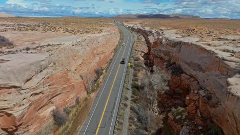 Highway-Between-Red-Rock-Cliffs-Of-Arches-National-Park,-Utah,-United-States