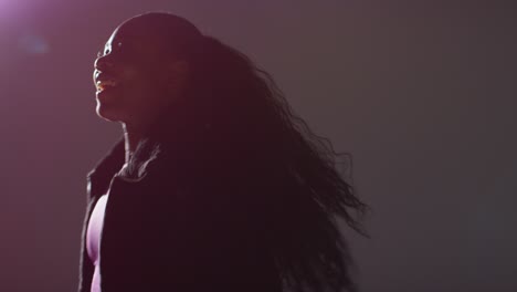 Backlit-Studio-Shot-Of-Casually-Dressed-Young-Woman-Dancer-Dancing-In-Spotlight