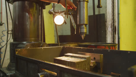 Caucasian-male-hands-factory-worker-at-a-factory-standing-at-a-workbench-and-operating-a-machinery