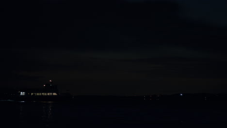 boat passing on water at night