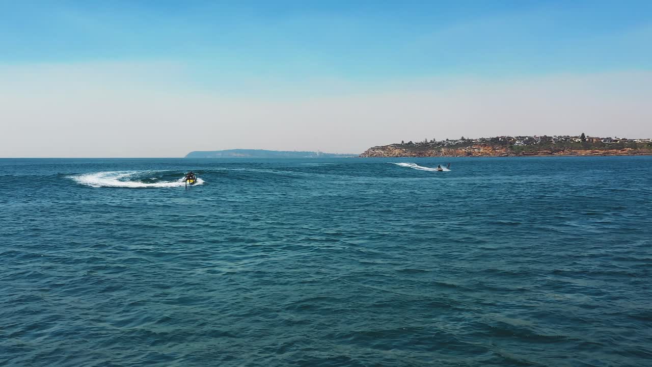 vista aérea del océano de jet ski remolcando atletas de hidrofolio en la ola del océano juntos