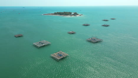 aerial view of fish farms in the ocean near an island