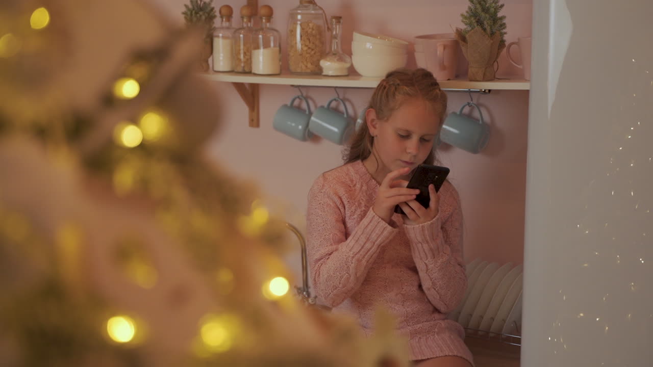 Little Girl Uses Her Phone To Send Merry Christmas Messages At Home
