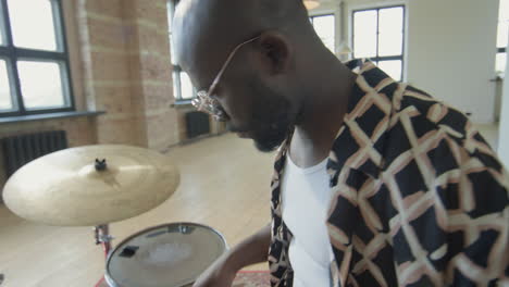 black musician playing drumset