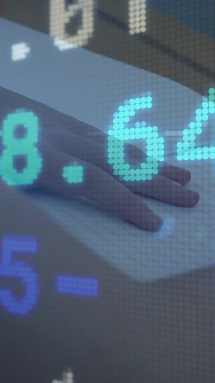 Stock market data animation over person writing in notebook