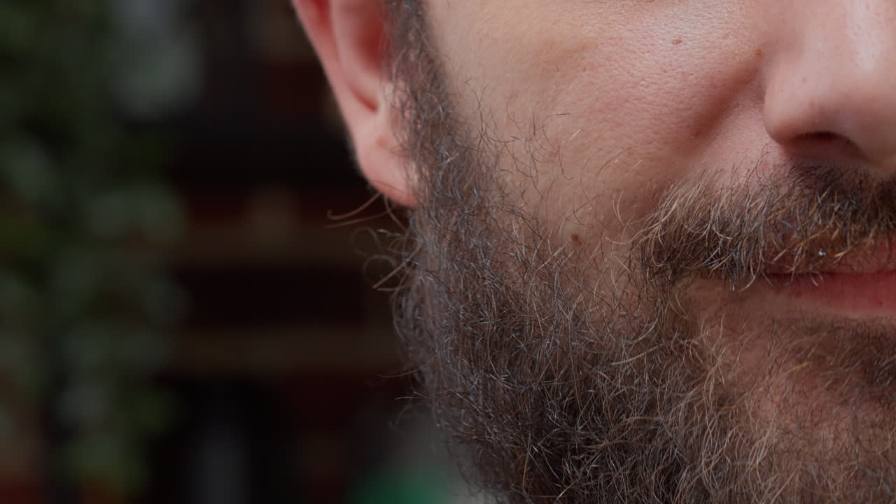 Macro shot portrait of happy man showing half face on camera