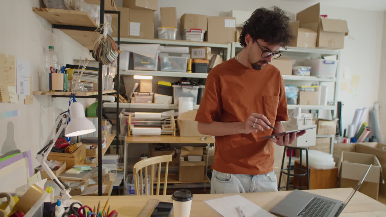 Male Worker Using Tablet in Delivery Service Warehouse