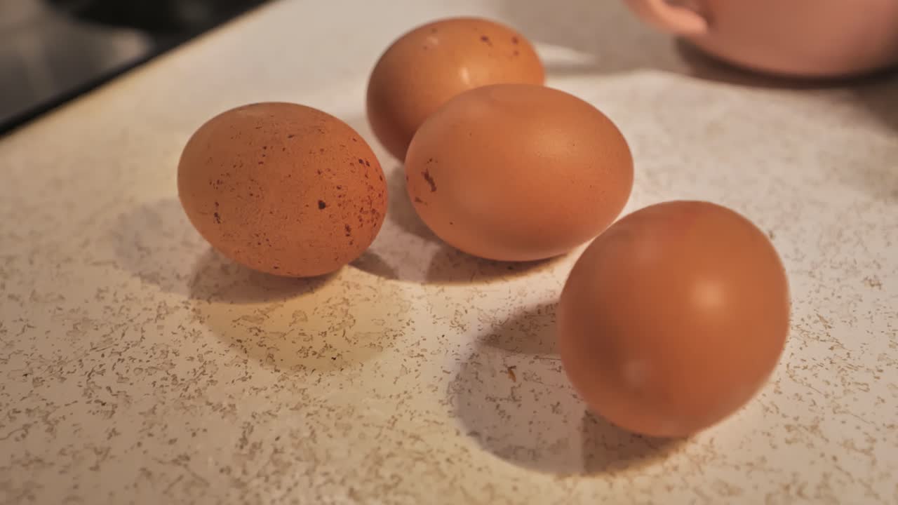 Farm fresh eggs on countertop as camera gently pans and smoothly shifts focus.