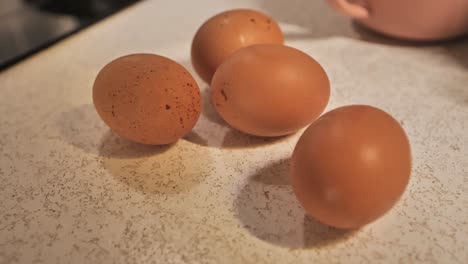 farm fresh eggs on countertop as camera gently pans and smoothly shifts focus.