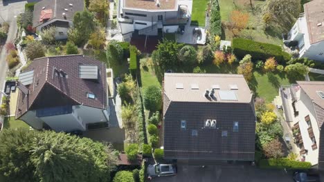 Top-drone-aerial-view-of-houses-in-a-small-town-in-Vaud,-Switzerland,-Lausanne