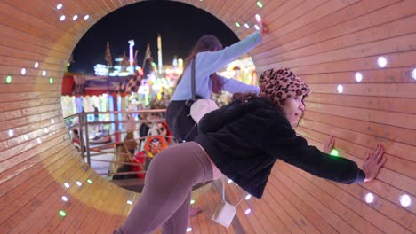 girls having fun at a funfair tunnel