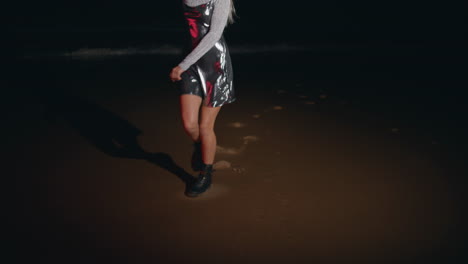 party girl dancing beach in light at night. carefree happy model enjoying summer