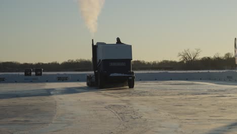 Zamboni-ice-resurfacer-smoothening-ice-on-outdoor-hockey-rink,-slow-motion