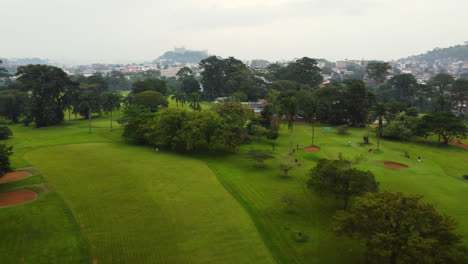 Golf-course-in-Yaounde-city,-overcast-day-in-Cameroon,-Africa---Aerial-view