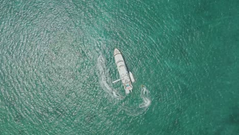 With-the-sun-glinting-off-the-waves,-the-jet-skis-created-a-mesmerizing-spectacle-as-they-circled-effortlessly-around-the-stationary-yacht