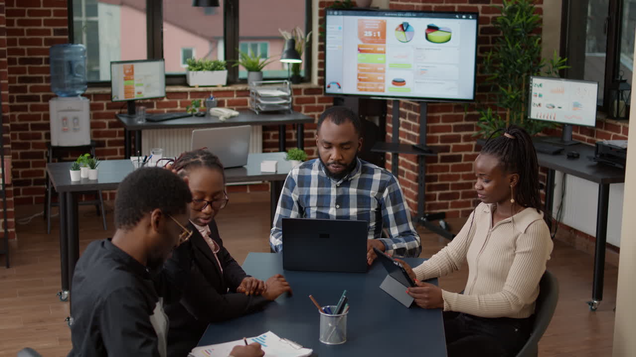 Team of african american people meeting in office to plan business strategy