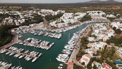 Aerial-view-of-Cala-d'Or-marina-in-Mallorca,-with-yachts-and-clear-waters