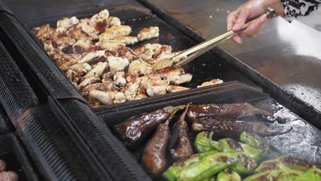 grilled chicken and vegetables on a street food stall