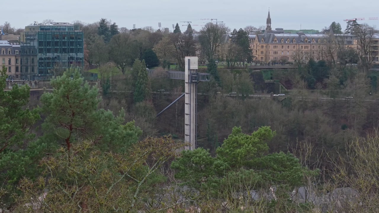 Footage of Luxembourg City elevator transporting people from ground level to the higher city level, highlighting urban mobility and scenic elevated city views.