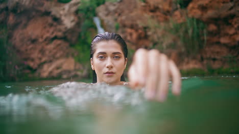 portrait swimming woman posing lagoon water. seductive lady stretching to camera