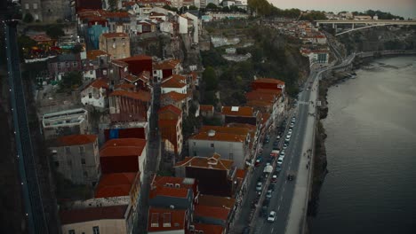 porto houses by the douro river in a cliffside on a summer evening