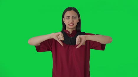 Upset-Indian-female-housekeeper-showing-thumbs-down-Green-screen