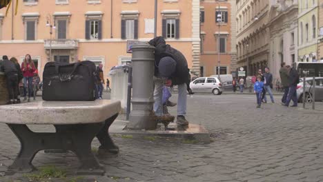 hombre bebiendo de la fuente de agua