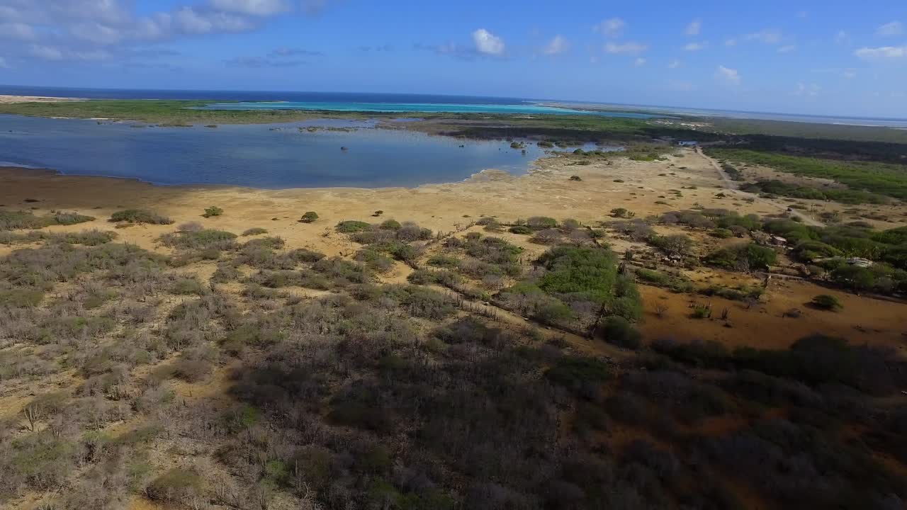 Aerial view of a natural landscape with a lake and the sea