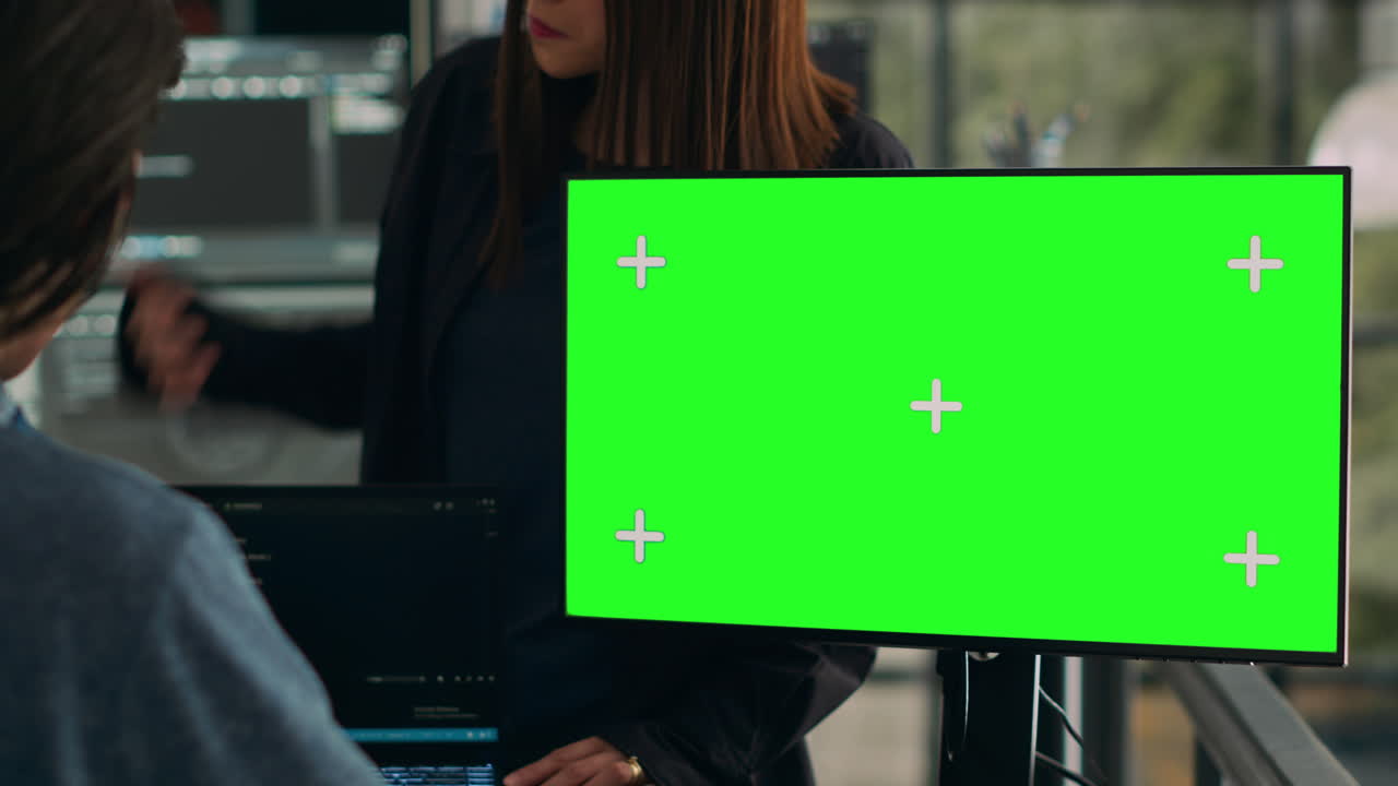 Software developers working on code programming with greenscreen