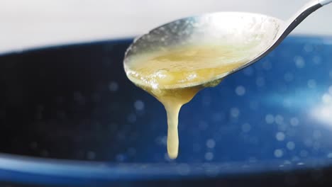 melted butter dripping from spoon