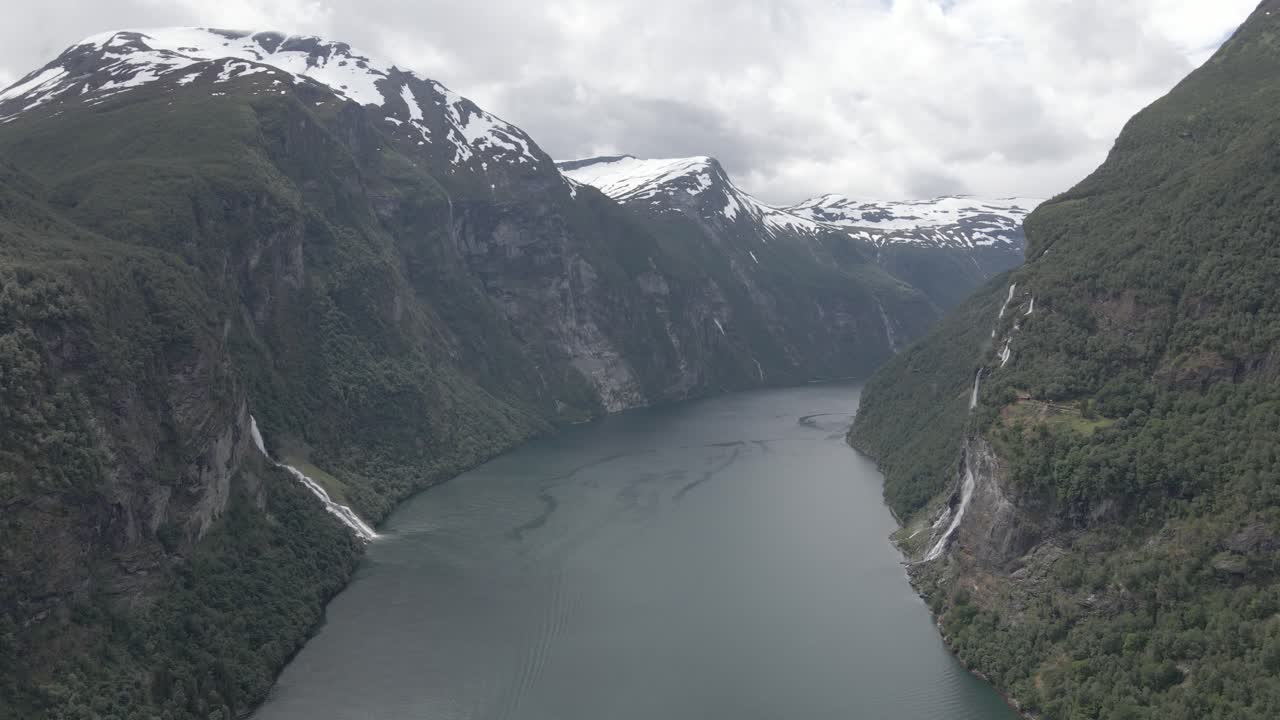 Vista aerea del maestoso fiordo di Geiranger con cime innevate e cascate, Norvegia
