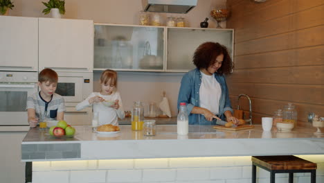 family enjoying breakfast together in a kitchen.