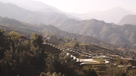 layers of hazy mountains and rice terraces in the mountains of sapa, vietnam