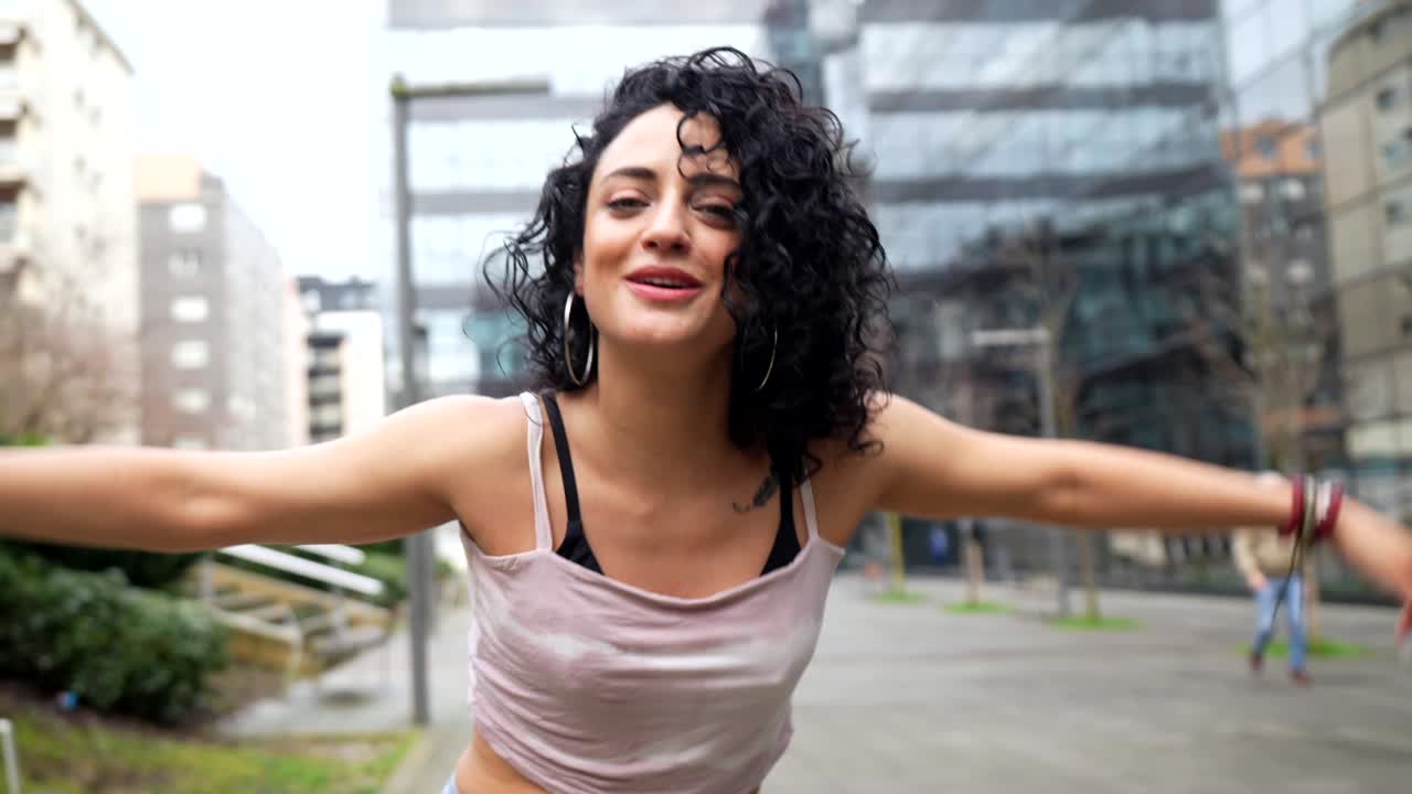 Woman Dancing Joyfully in Urban Setting