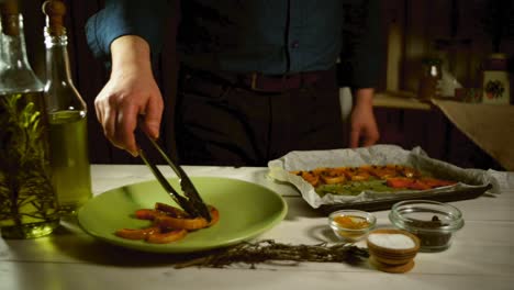 chef put baked pumpkin slice on plate. baked vegetable dish on rustic kitchen