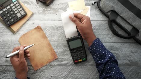 pos machine and long roll paper on table ,