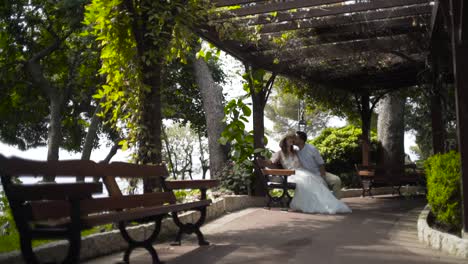 couple kissing in a park gazebo