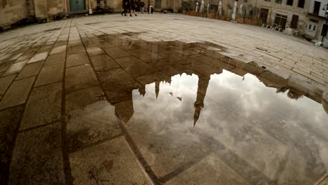 vertical panorama from reflection in puddle of selimiye mosque to building