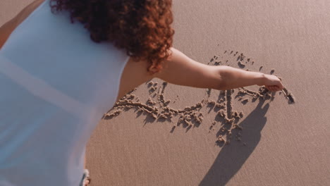 young-woman-writing-2019-on-sandy-beach-for-new-years-celebration-summer-vacation-travel