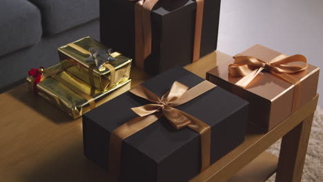 close up of gift wrapped presents on table in lounge at home 7