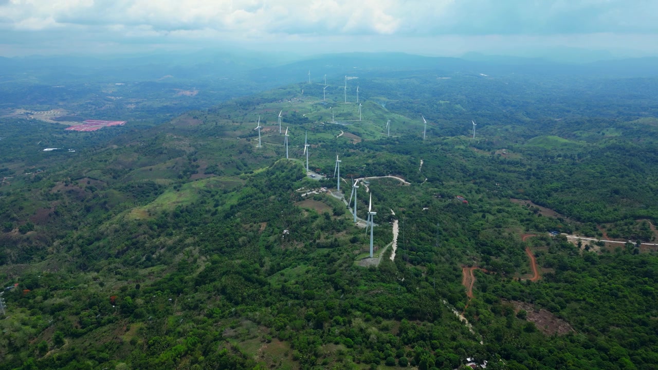Wide drone view of Ponte Verde real estate development in Pililla, Rizal with residential areas, open land, mountain terrain, and views toward Laguna de Bay.