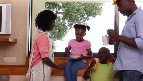 Family-together-in-kitchen-having-breakfast