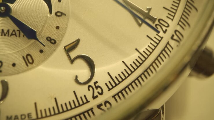 Close up of watch arrows ticking