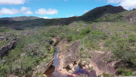 Aerial-view-of-an-old-bridge-with-brown-river-flowing-underneath